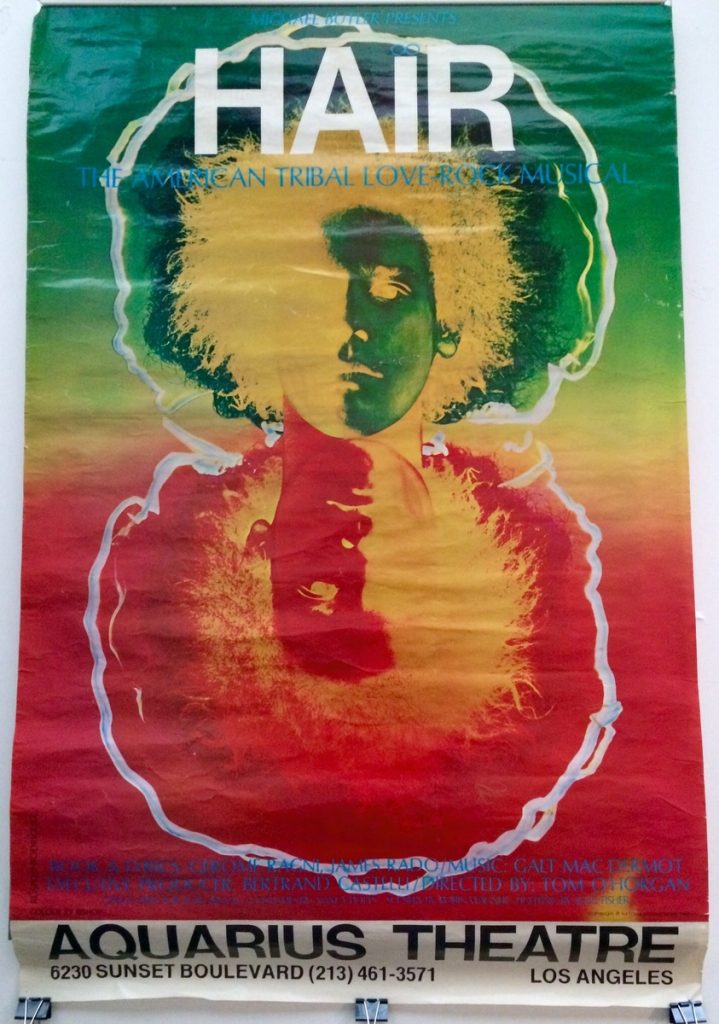 A vintage poster of "Hair", the American Tribal Love Rock Musical, with a trippy inverted head. This poster advertises a performance at the Aquarius Theatre in Los angeles.